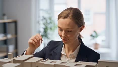 an architect works on an urban planning model