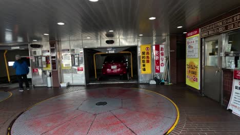 car enters and exits automated parking facility