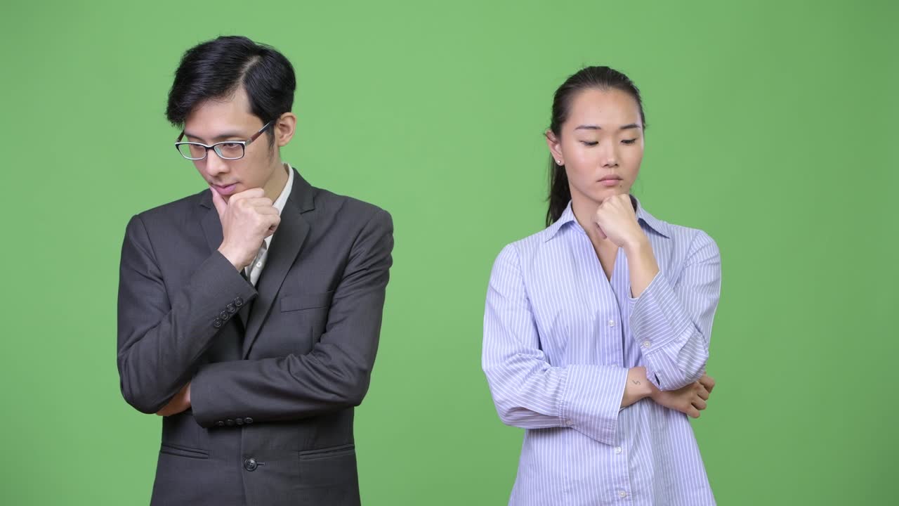 Young Asian business couple thinking together