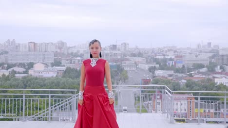 woman dancer in red dress on rooftop