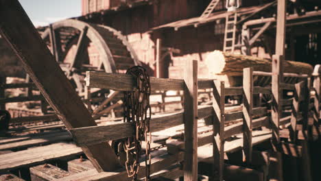 rustic wooden structures and machinery in a historical setting during daylight