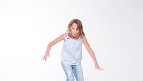 girl jumping against white studio background