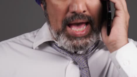 middle aged businessman in turban having a heated phone call