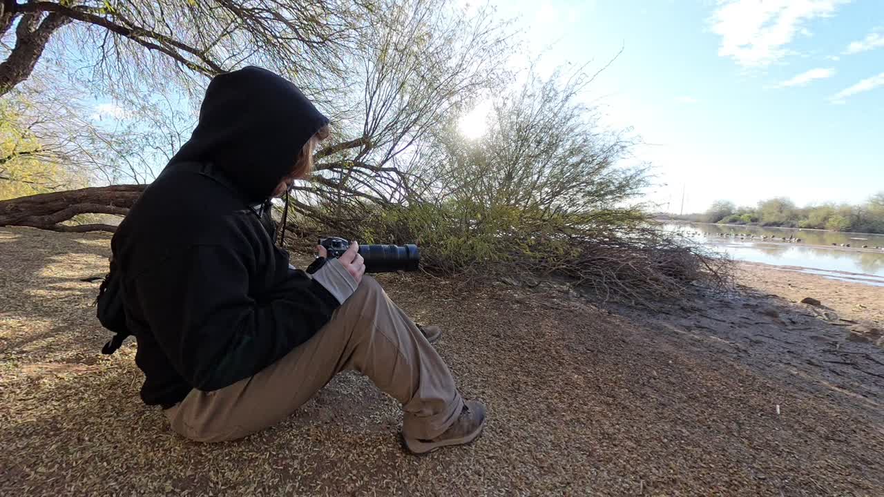 Hobby photographer taking pictures in Gilbert Arizona Riparian Preserve.