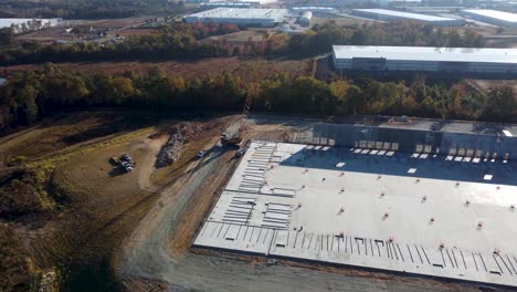 A-drone-dollying-into-a-heavy-crane-lifting-concrete-panels-into-place