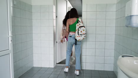 teen girls leaving the bathroom