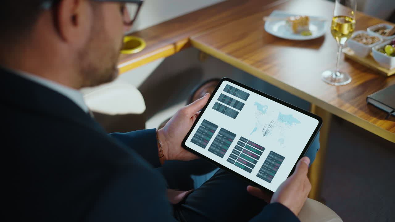 Man analyzing financial data on tablet