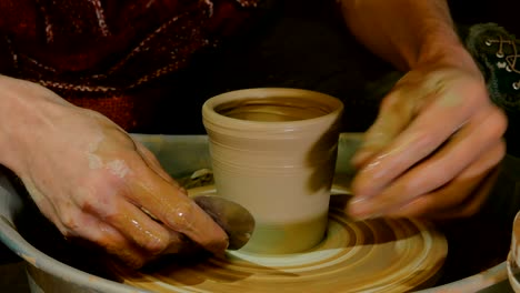 taza de conformación de alfarero profesional con herramienta especial en taller de cerámica
