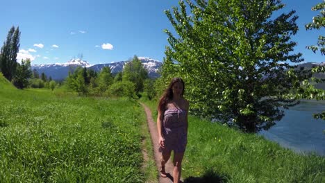 woman walking on path in forest