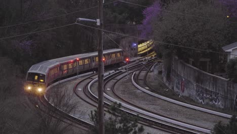 a train emerges out of a tunnel at night