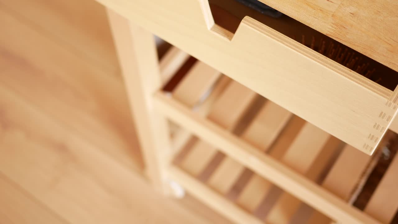 Person placing soap in a drawer with towels, brushes, and a comb