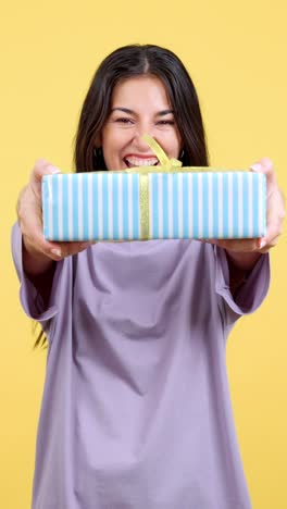 happy young woman presenting a gift