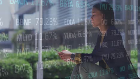 Animation-of-trading-board-over-thoughtful-biracial-woman-sitting-and-scrolling-on-cellphone