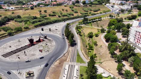 drone shot descending with a small parallex by a roundabout