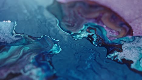 close-up of vibrant blue and pink inks diffusing in water, creating an abstract, fluid art pattern