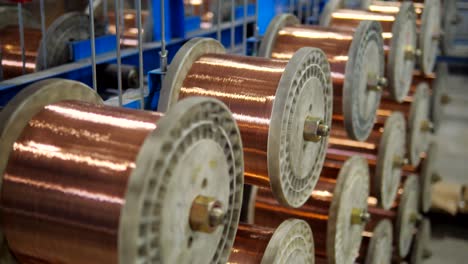 copper cable rolling on reels in industrial plant. production parts for electric motors