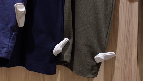 clothes hanging in a store with security tags