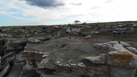 drone pull back over rocky cliff edge, asunden raukfield, sweden