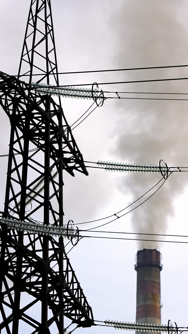 Electrical substation with power lines. Power mast of high voltage transmission line. Vertical video