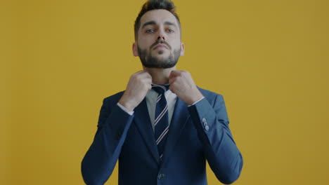 businessman adjusting tie