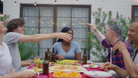 friends enjoying an outdoor dinner party