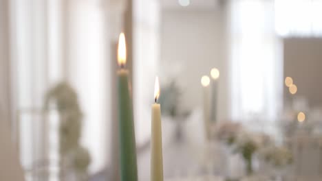 burning candles with warm glow in softly lit elegant indoor setting