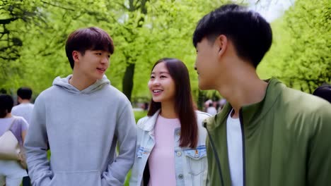 three young people are walking in a park, smiling