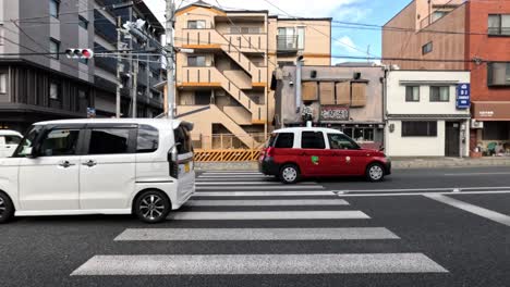 cars and pedestrians at a city intersection