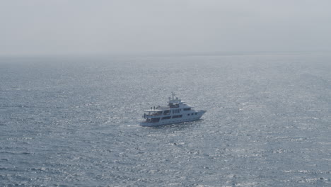 Drone-shot-of-white-boat-or-ship-on-the-ocean