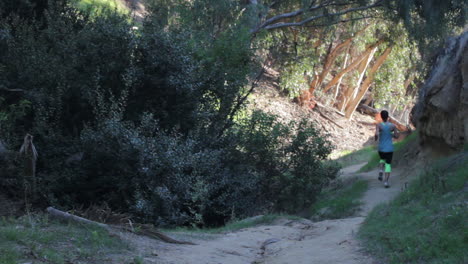 A-long-distance-runner-pushes-herself-through-a-shadowed-valley-and-into-the-light