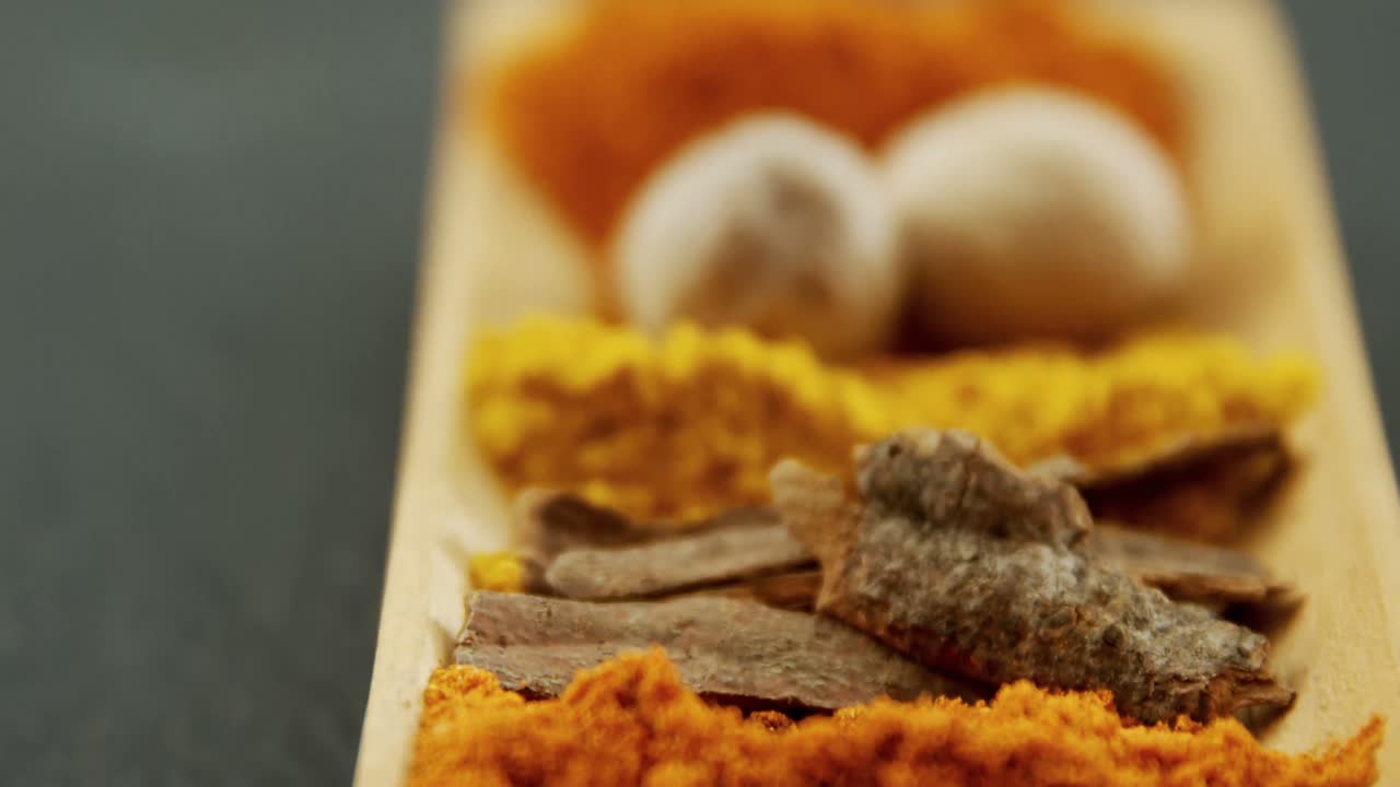 Various spices on wooden tray 4k