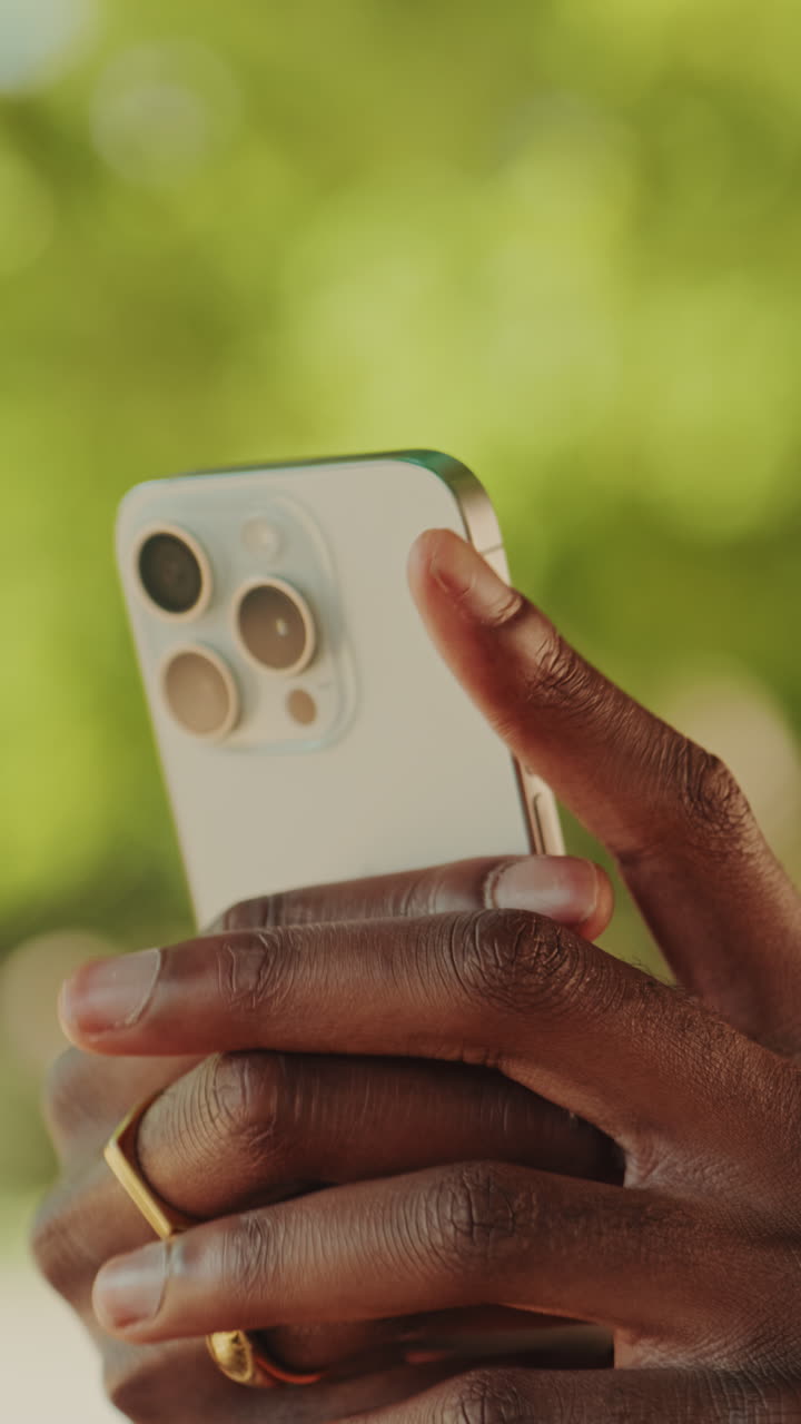 Close-Up of Hand Holding Smartphone and Pressing Side Button