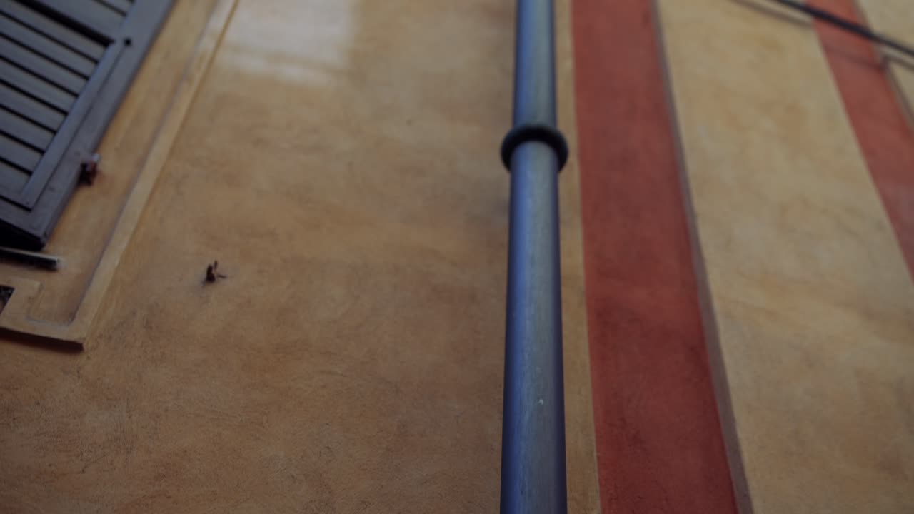Italian Building Facade with Shutters and Gutter