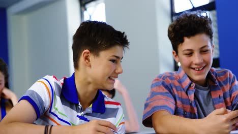 Estudiante-Usando-Teléfono-Móvil-En-El-Aula