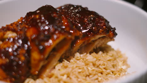panning view of japan teriyaki miso chicken king kebab resting on bed of egg fried rice with delicious sticky glaze across the top. japanese cuisine 4k.