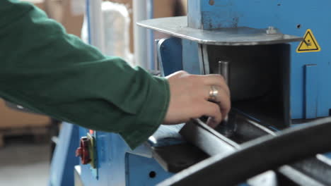 Worker-sawing-detail-on-machine.-Factory-worker-on-circular-saw-in-workshop