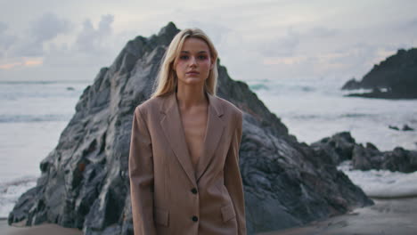 confident woman looking camera on go at beautiful ocean coast. fashion model