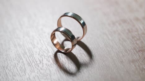 wedding rings and play with light on the wooden background