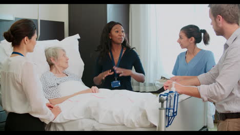 senior female patient and medical staff meeting at hospital