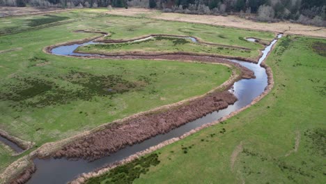 Beautiful-4K-aerial-shot-showcasing-water-at-Dean-Creek-in-Reedsport,-Oregon