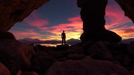 adventurous man standing in scenic mountain cave