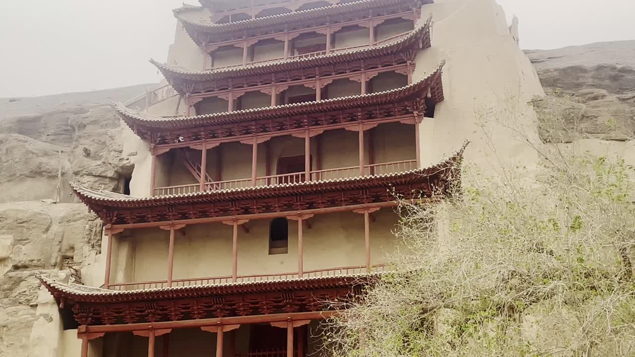 The Mogao Caves, Thousand Buddha Grottoes in Dunhuang, an oasis located on the Silk Road, in Gansu province, China tilt up view