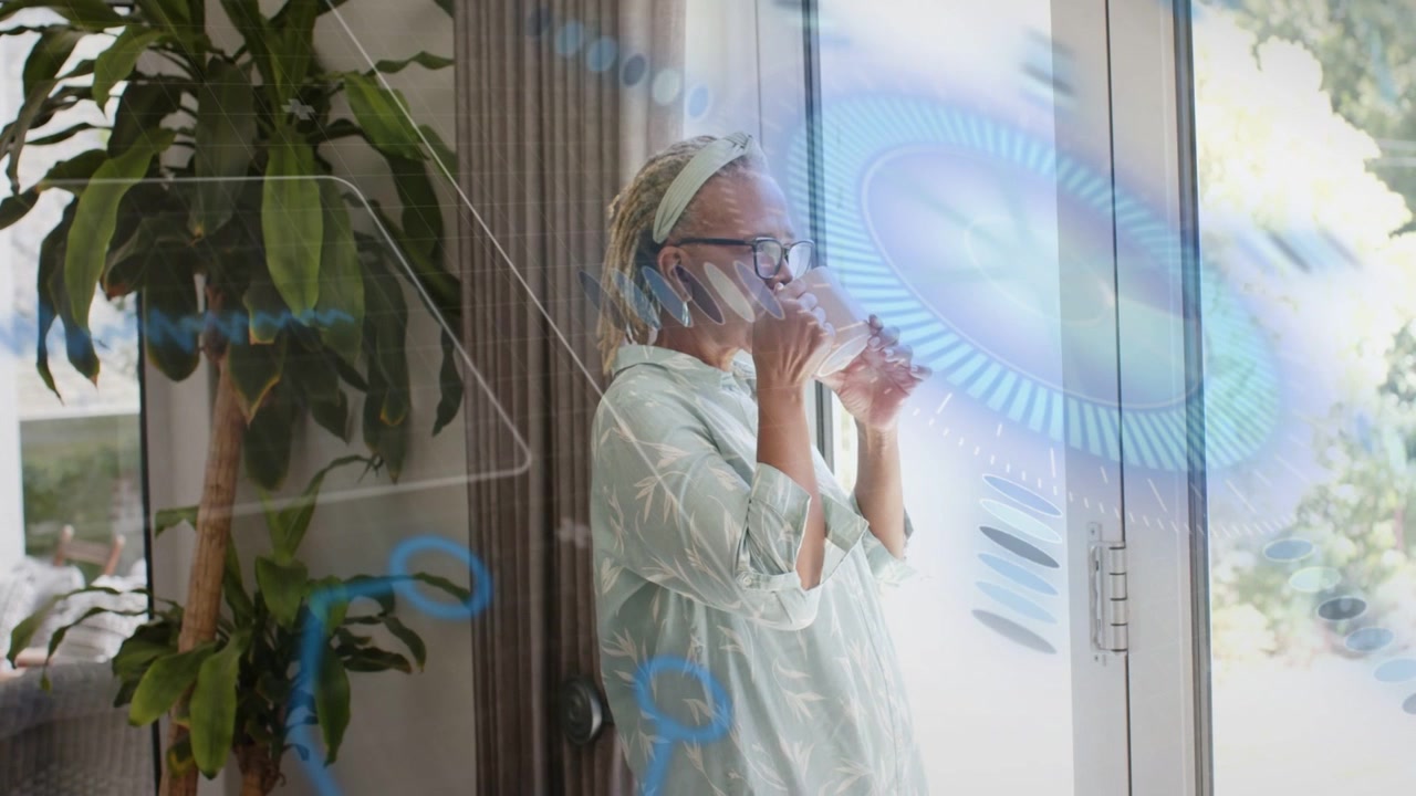 Senior woman lifting clear glass, sipping for water by door, health AR overlay sweeping beside her