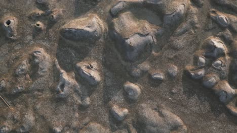 rough terrain of barren lava field in iceland, downwards drone view