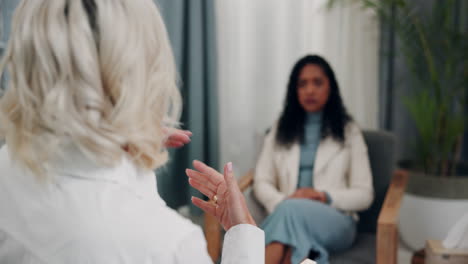 a woman talking to a therapist in an office.