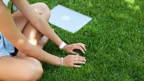 woman relaxing in a park with a laptop