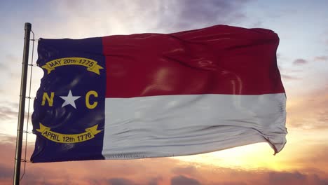 flag of north carolina waving in the wind against deep beautiful sky at sunset