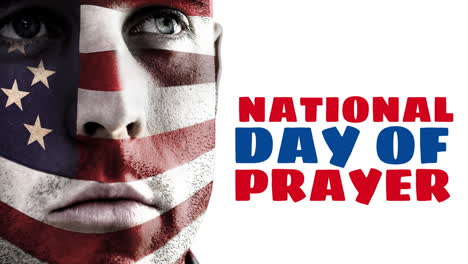 animation of national day of prayer text with american flag over caucasian man's face