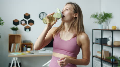 woman drinking water in a home office