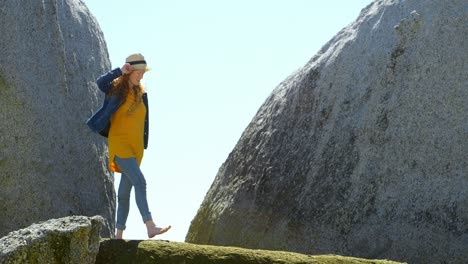 Mujer-Caminando-Sobre-Una-Roca-En-La-Playa-4k